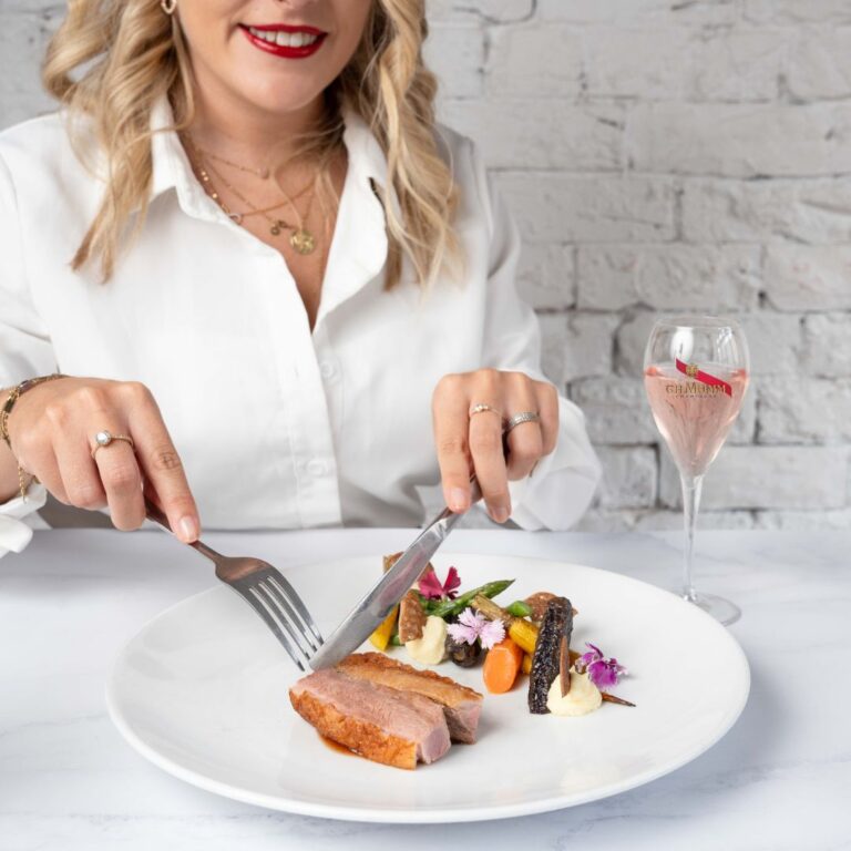 A woman enjoying the Mumm Dinner at Four Frogs Randwick